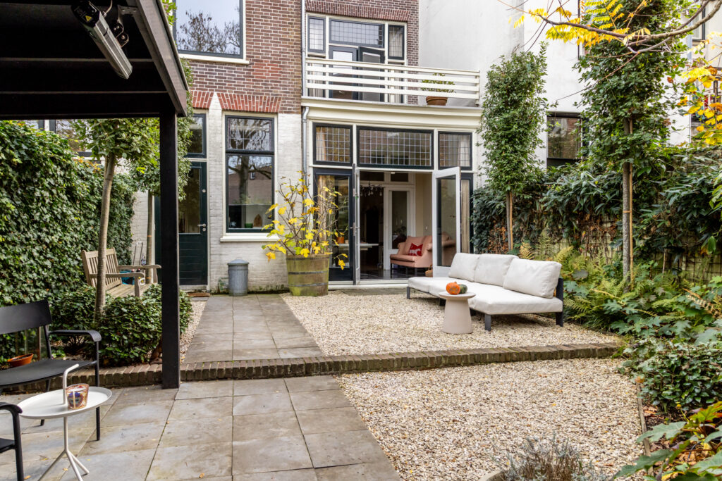 Cozy backyard patio with plants and seating area.