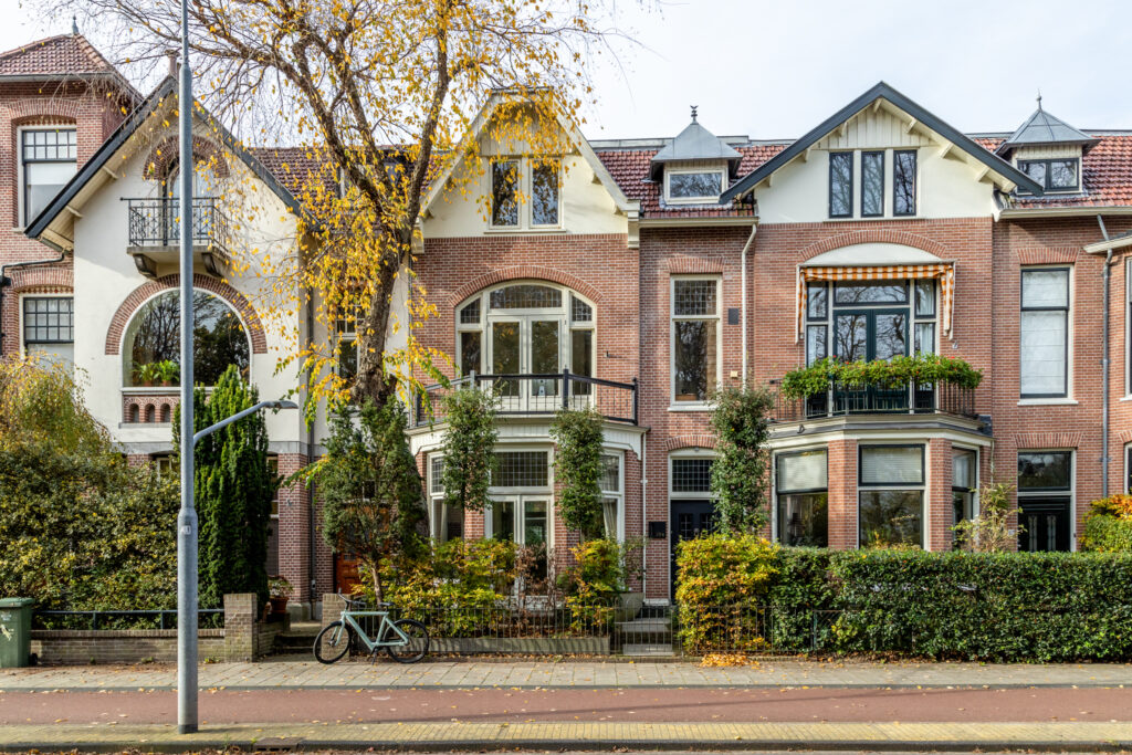 Historic brick townhouse with trees in autumn