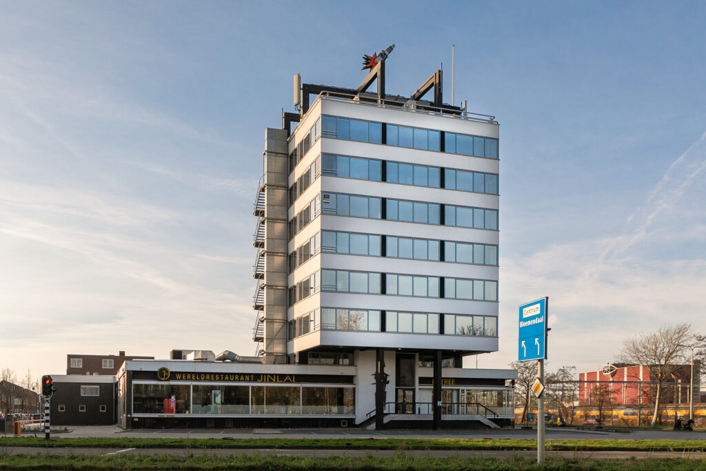 Modern office building with restaurant on ground floor.