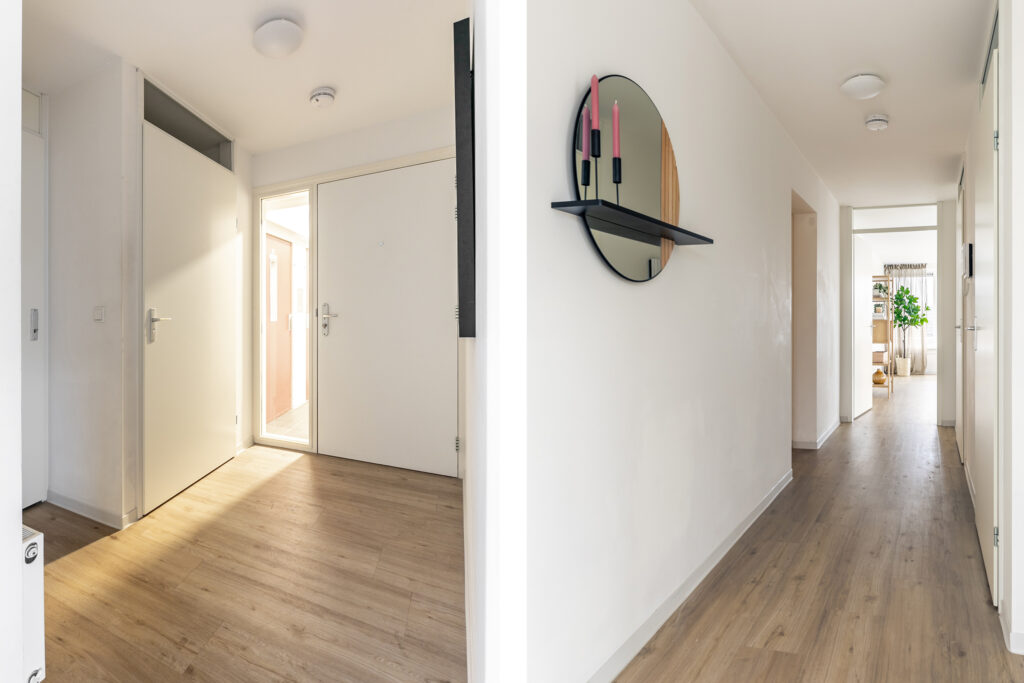 Modern hallway with light wood flooring.
