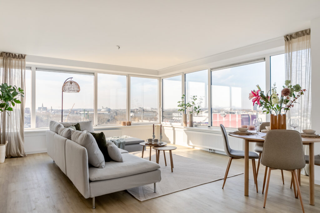 Modern living room with city view windows.