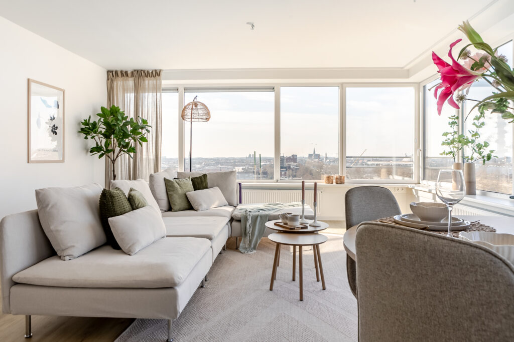 Modern living room with large windows and cozy seating.