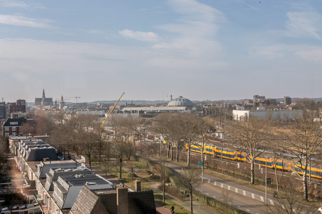 Cityscape with train and construction, clear sky.