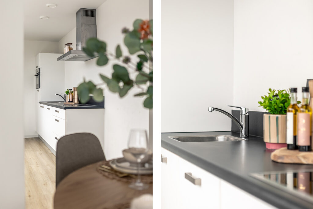 Modern kitchen with sleek white cabinets and decor.