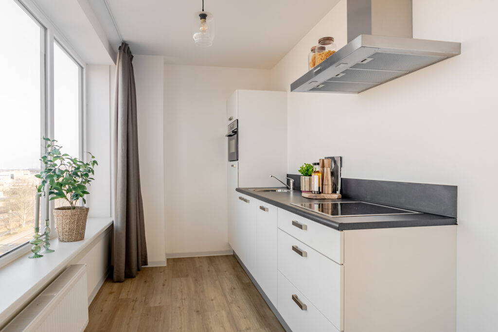 Modern kitchen with sleek white cabinets.