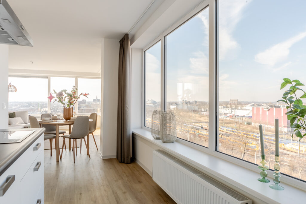 Spacious dining area with large windows and city view.
