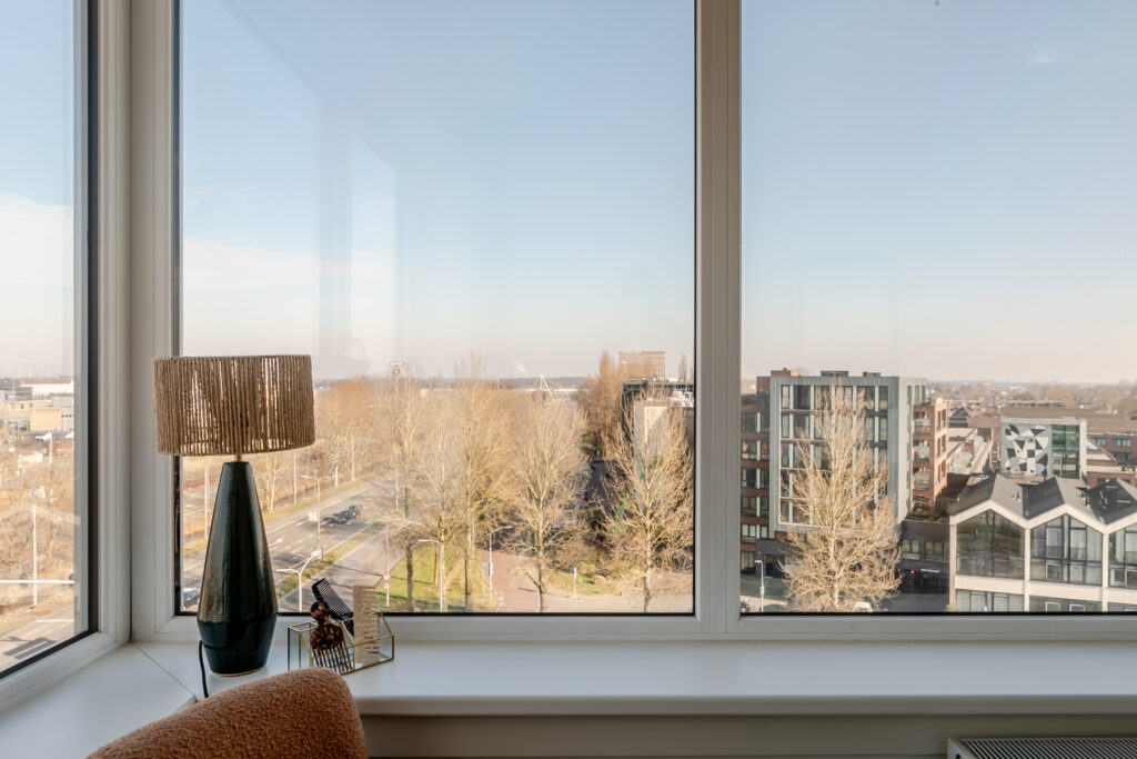 City view from window with modern buildings.