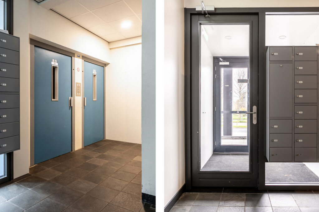 Building entrance with blue doors and mailboxes.