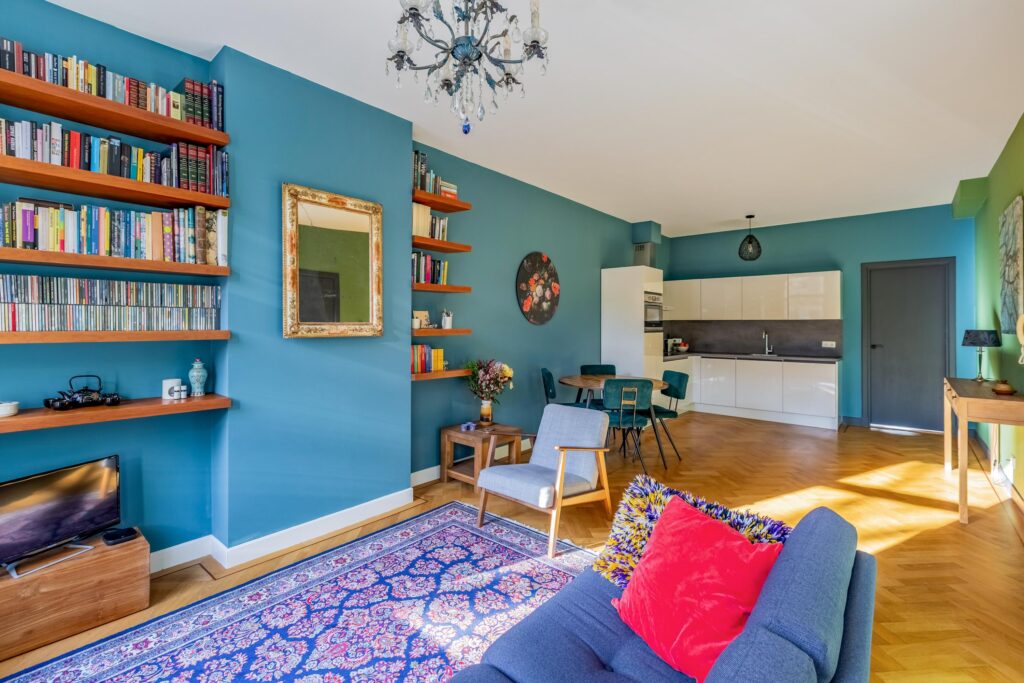 Modern living room with blue walls and cozy decor.