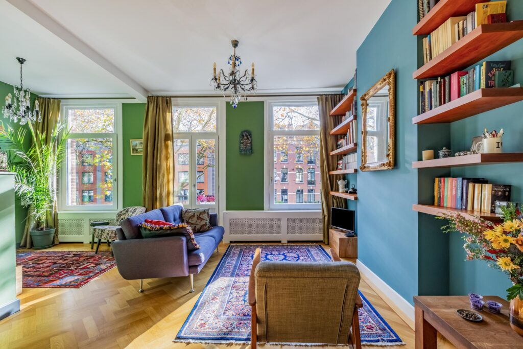 Cozy living room with bookshelves and large windows.