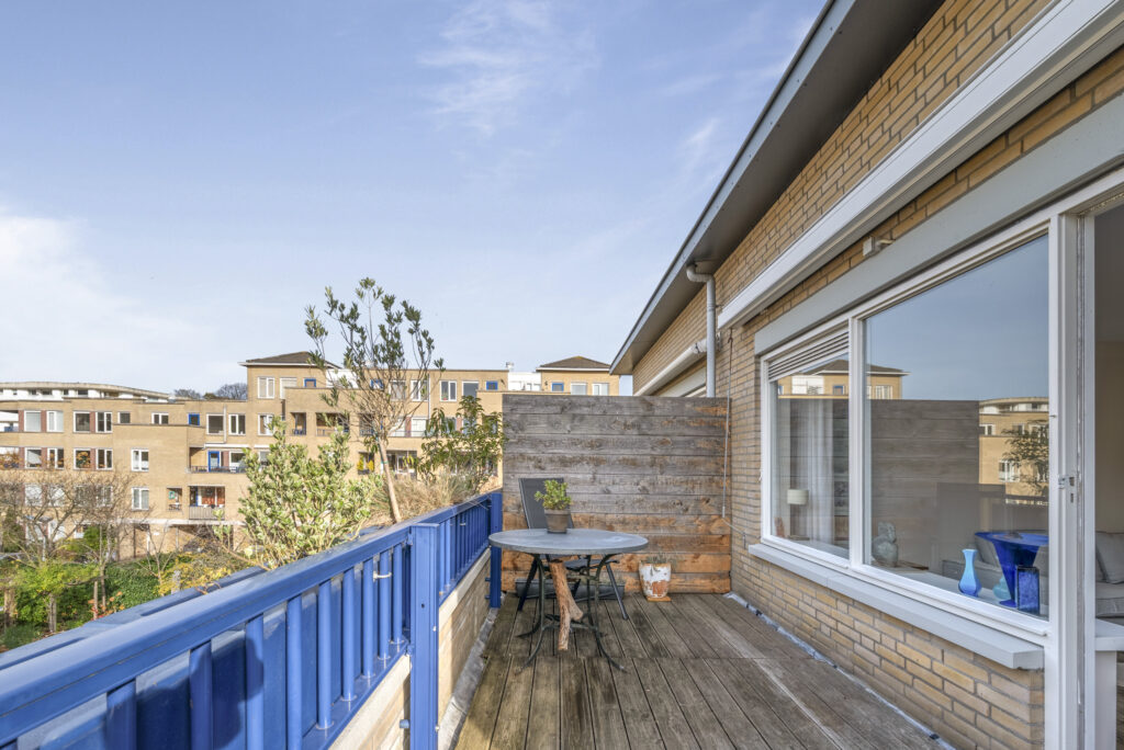 Cozy balcony with plants and table.