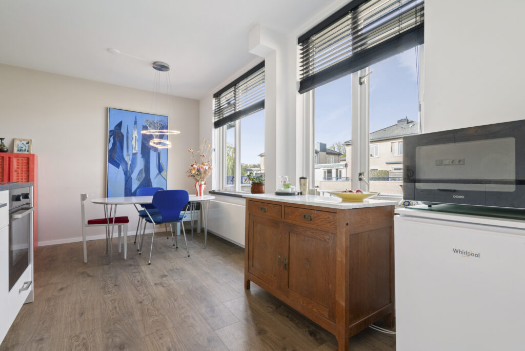 Modern kitchen with dining table and artwork