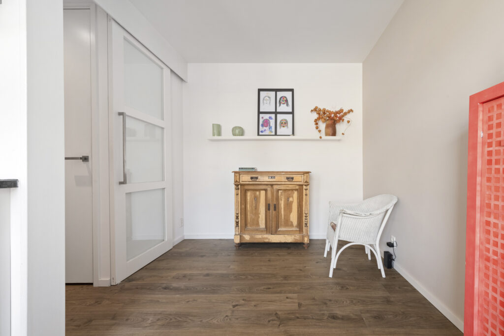 Minimalist room with wooden cabinet and wicker chair