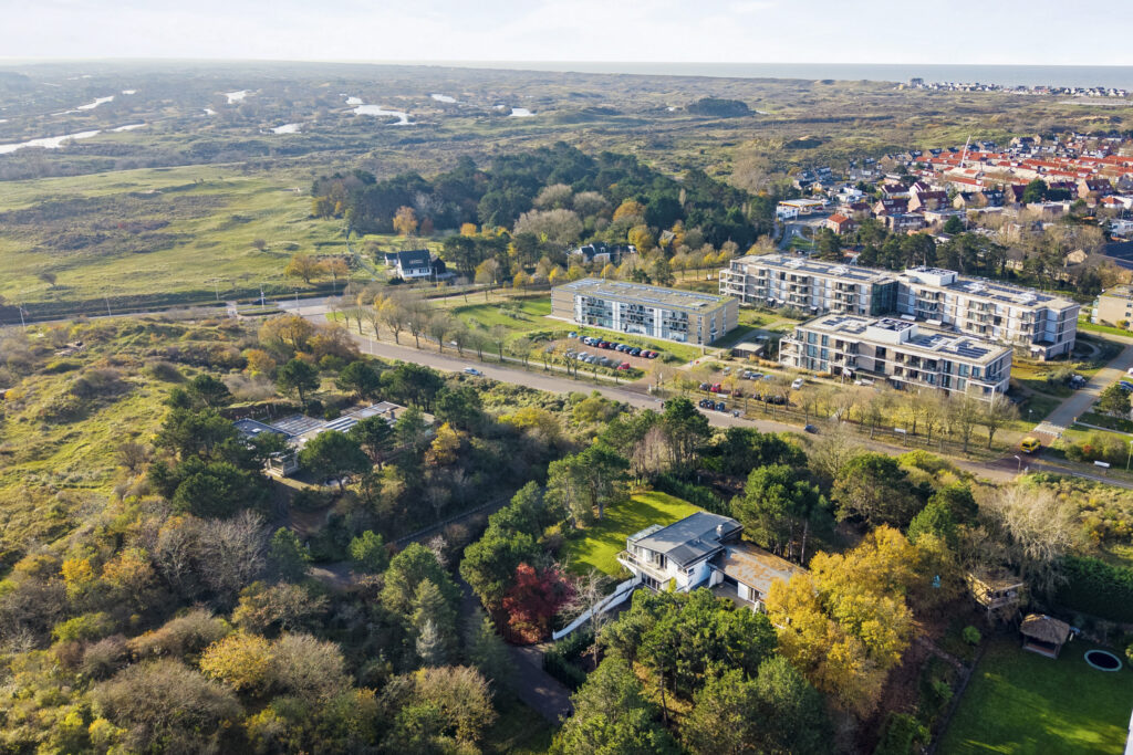 Aerial view of countryside with buildings and trees.