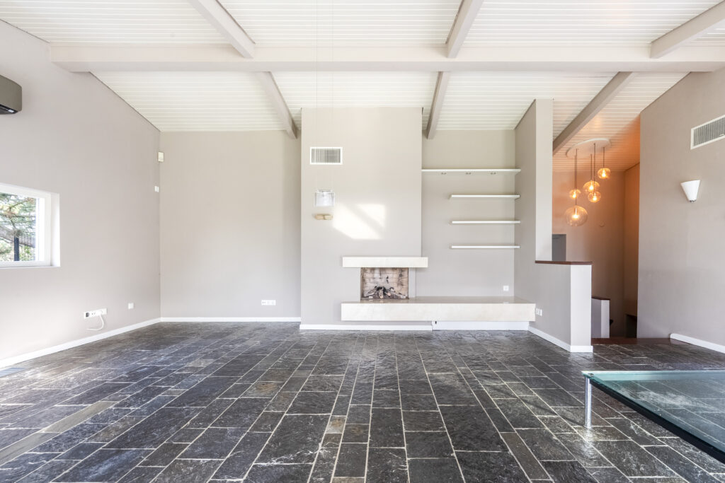 Spacious modern living room with stone flooring.