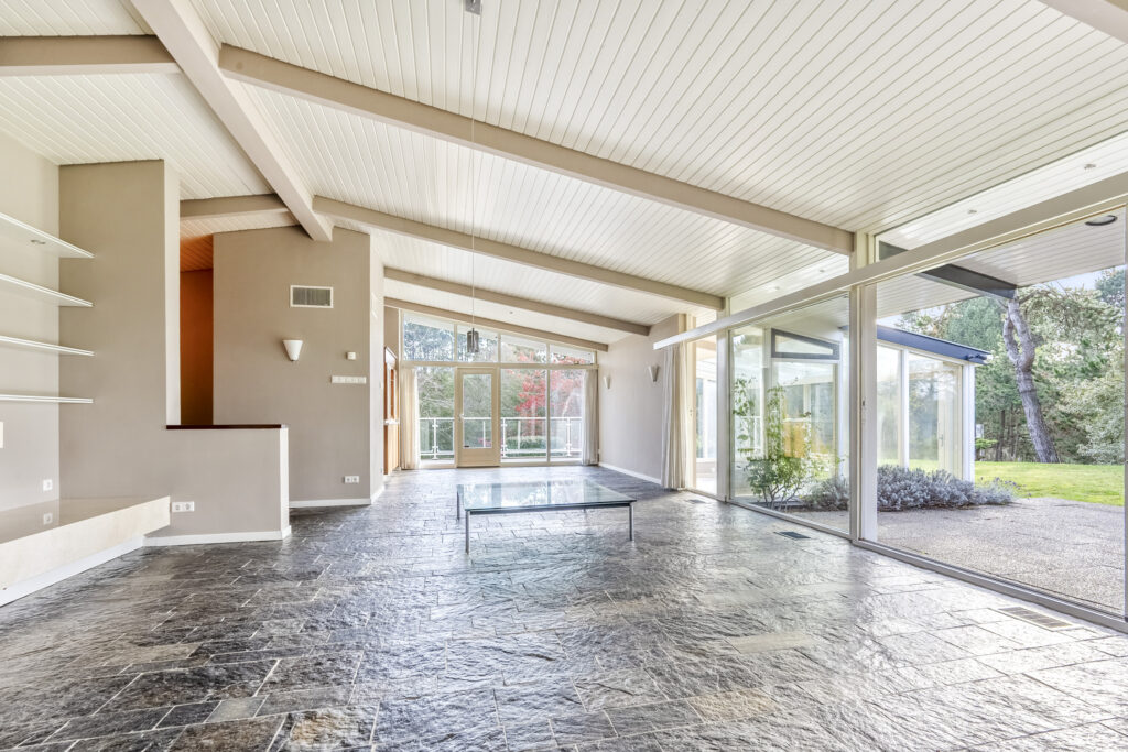 Spacious modern living room with large glass windows.