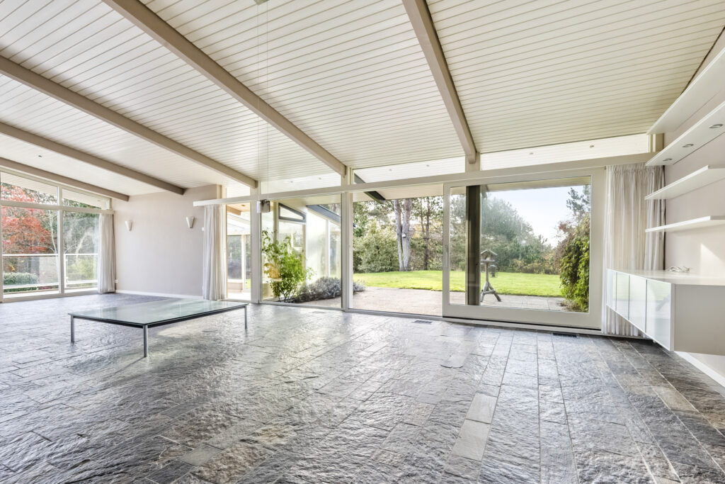 Spacious room with large windows and garden view.