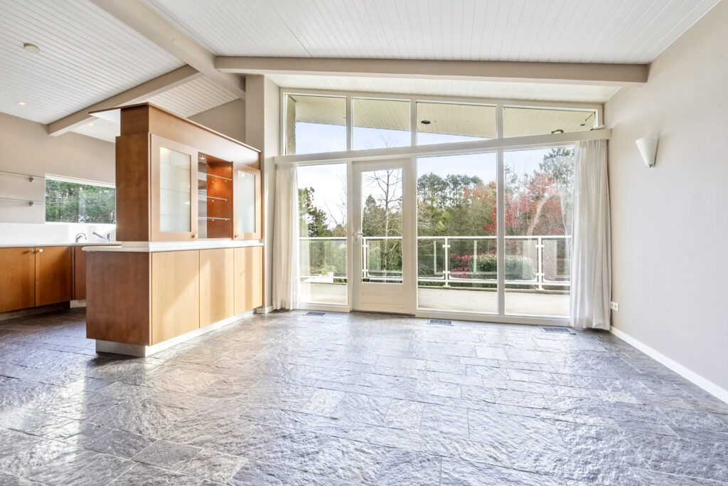Spacious kitchen with large windows and patio view.