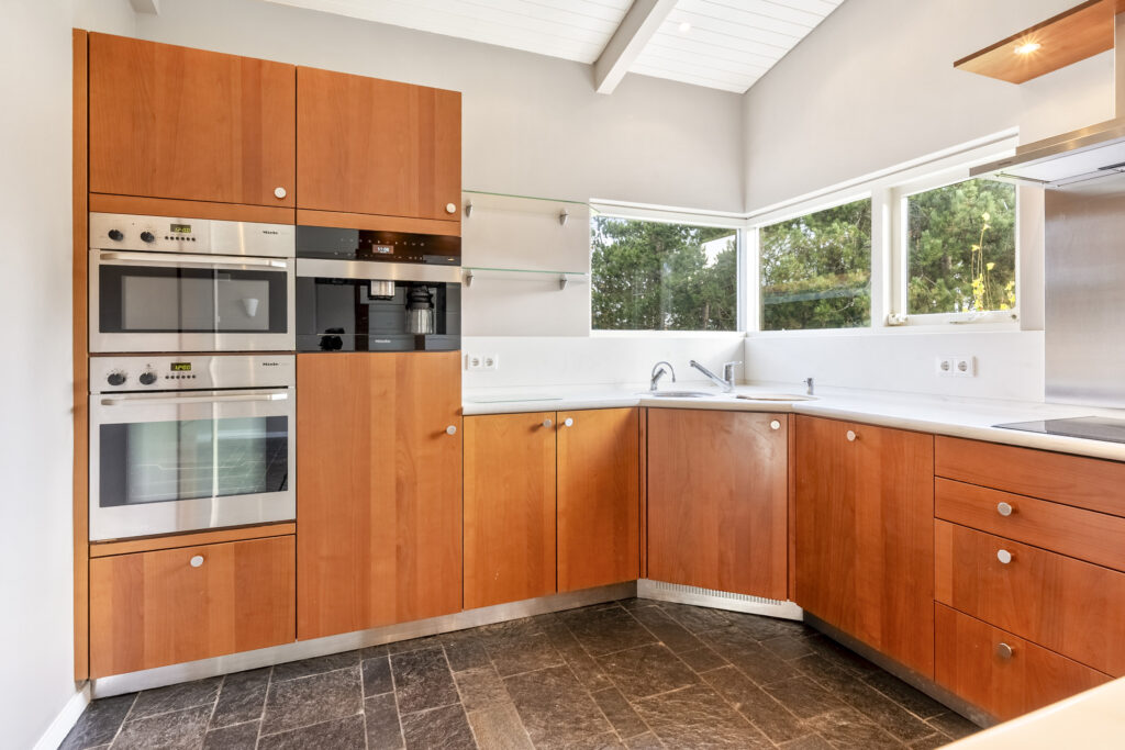 Modern kitchen with wooden cabinets and appliances