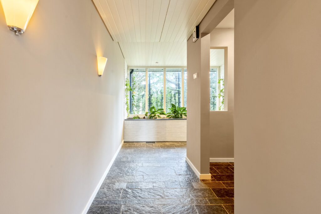 Bright hallway with large window and plants