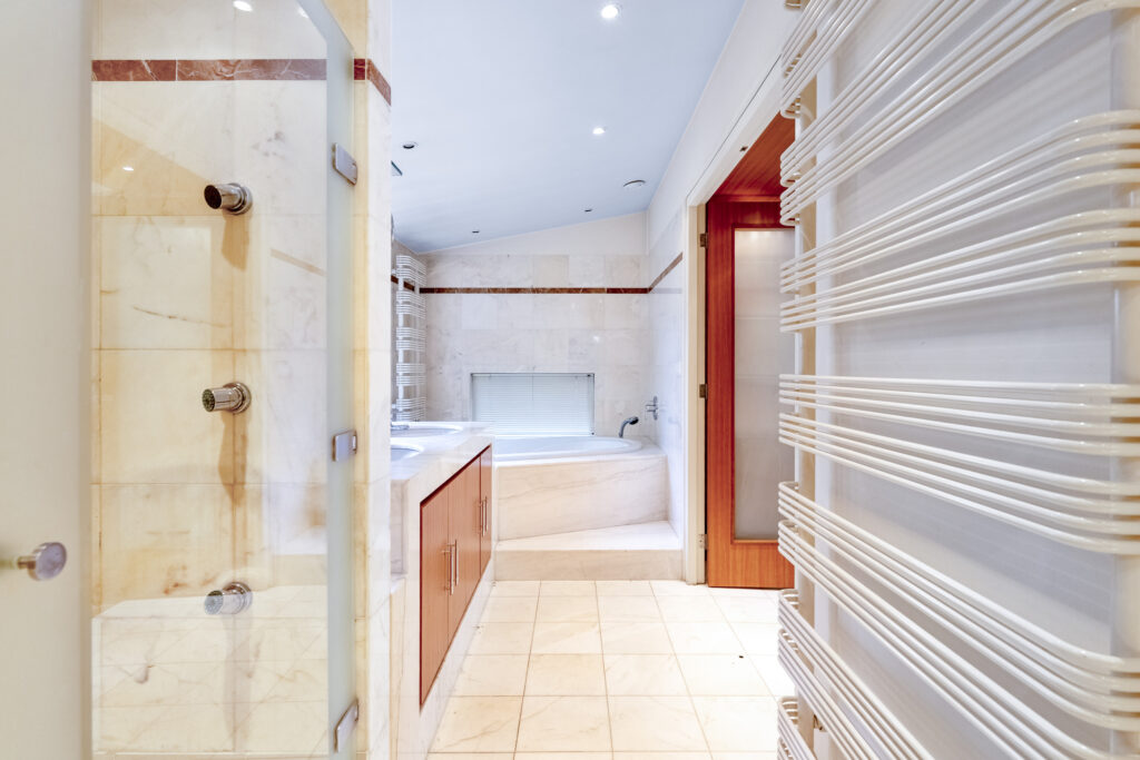 Modern bathroom with marble tiles and tub