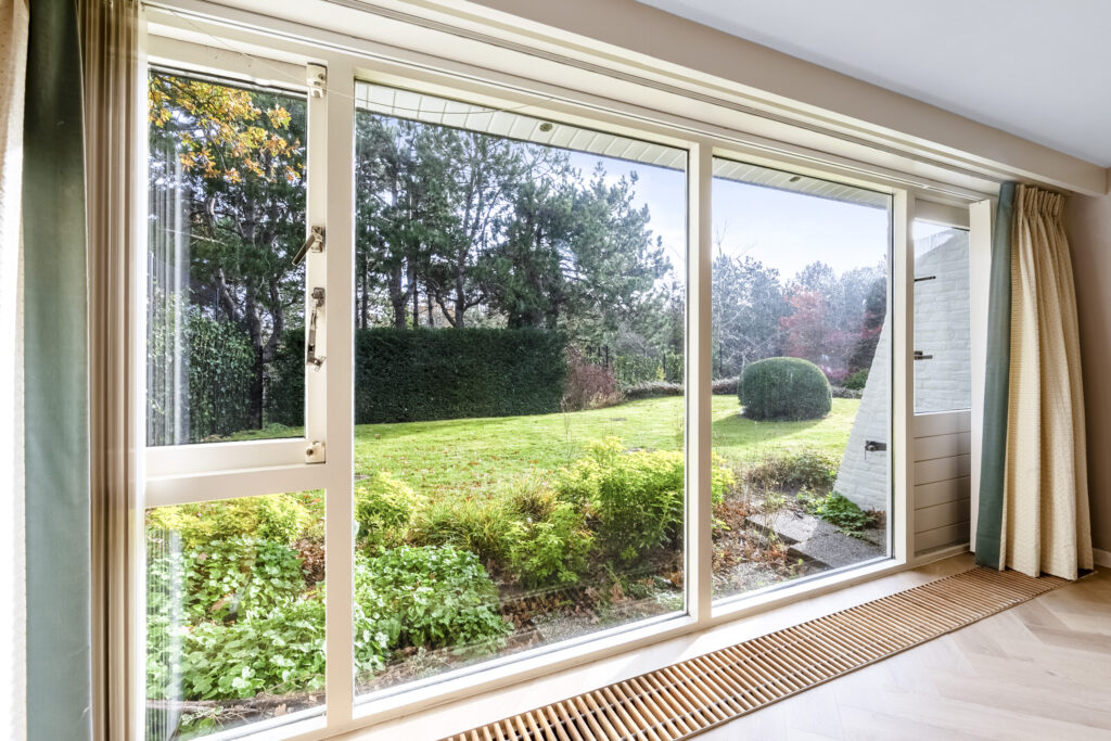 Scenic view through large window overlooking garden