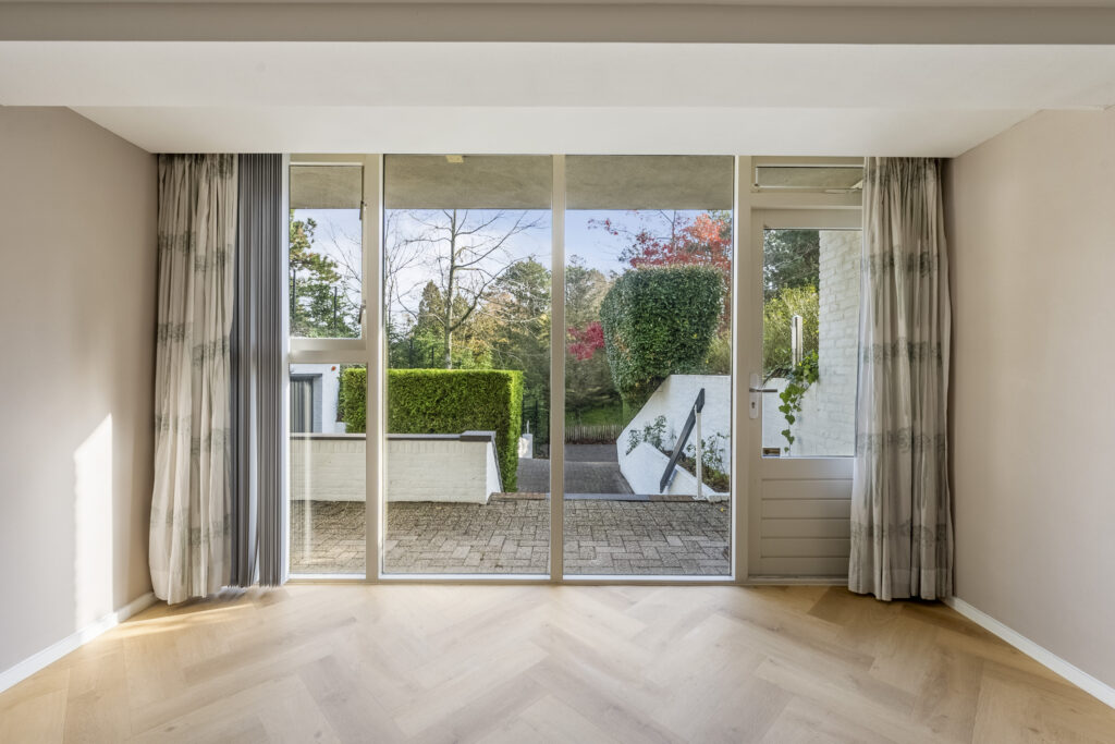 Bright room with large window and outdoor view.