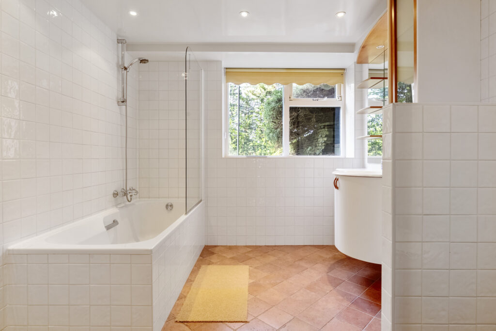 Bright bathroom with bathtub and window