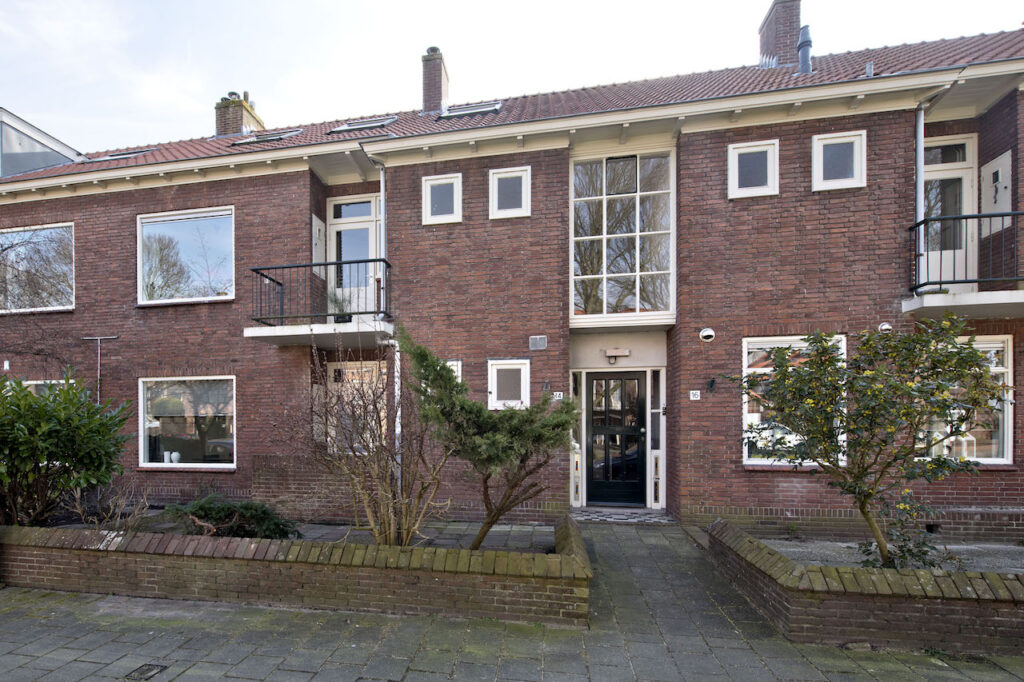 Red brick townhouse with front garden.