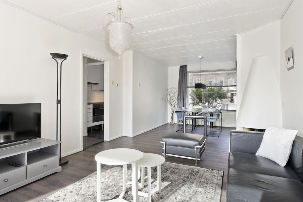 Modern living room with dining area and kitchen.