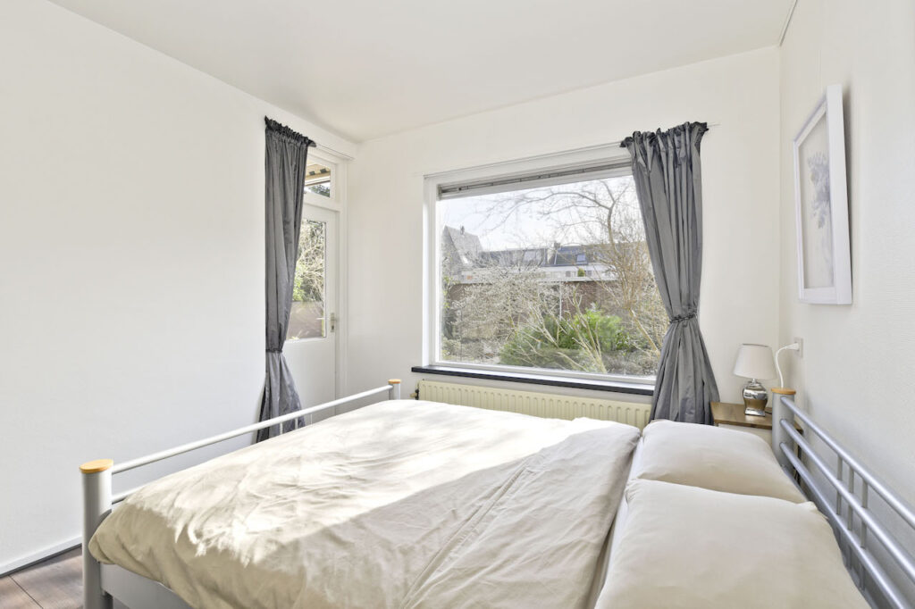 Bright bedroom with large window and simple decor