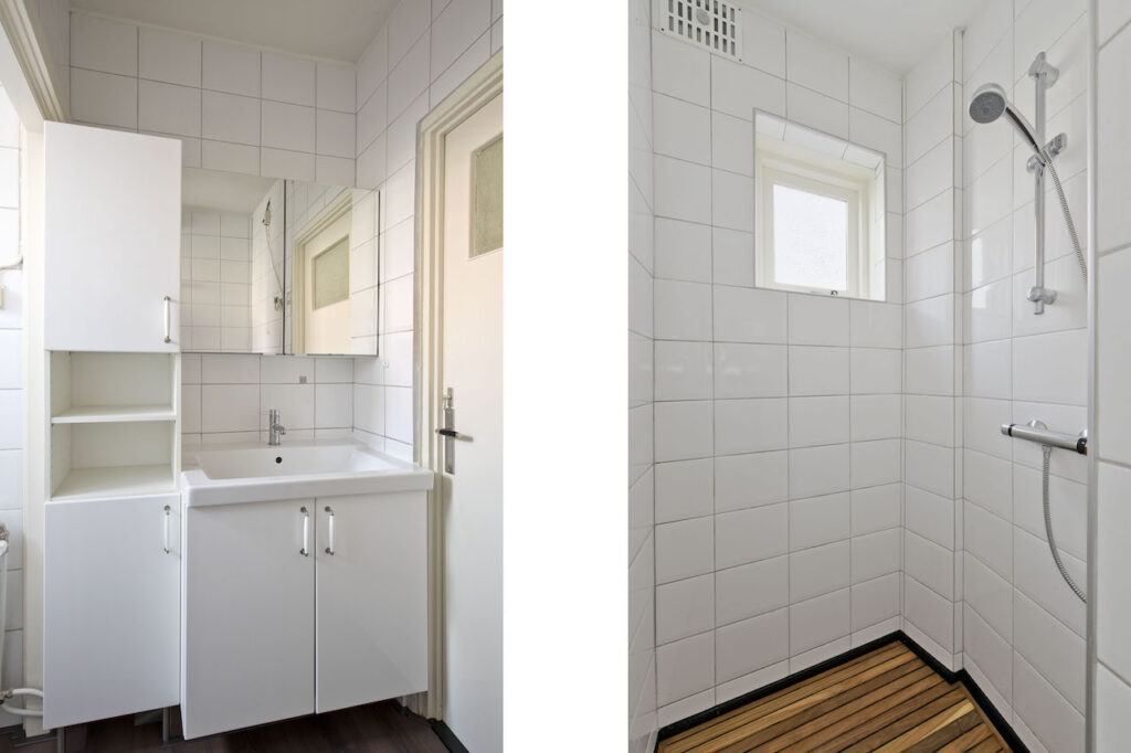 Modern white tiled bathroom with sink and shower.