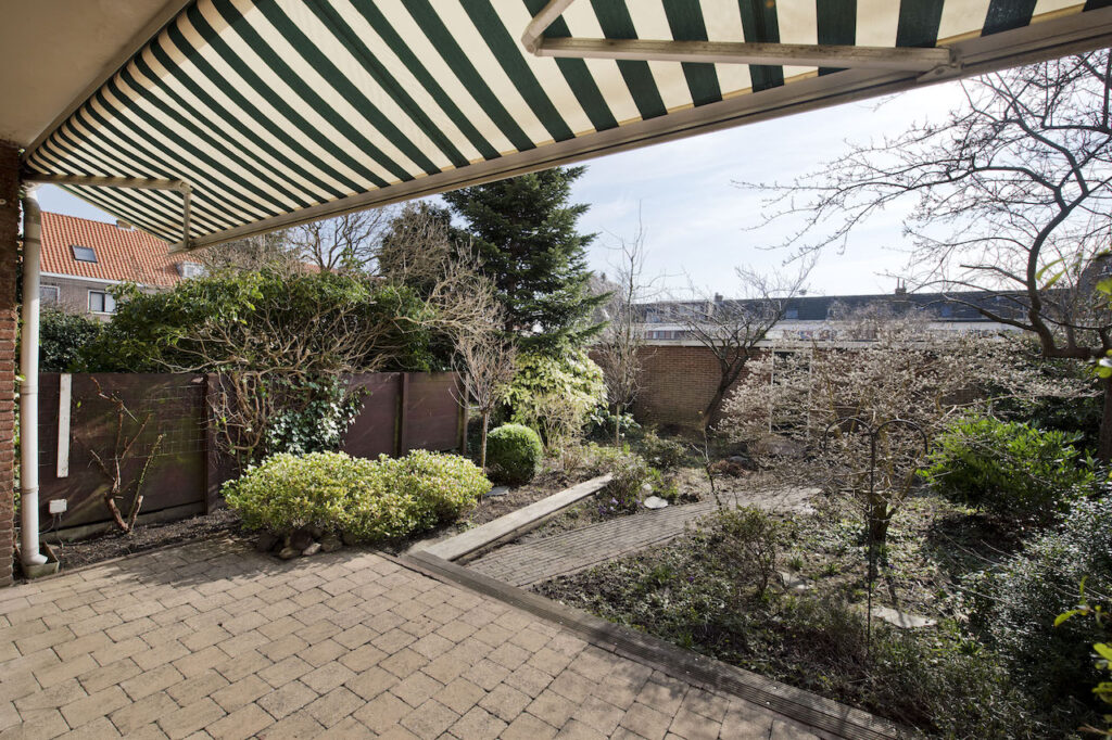 Sunny backyard with patio and awning