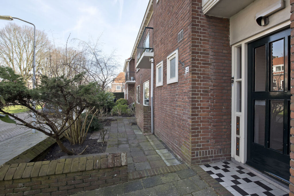 Brick house entry with garden and walkway