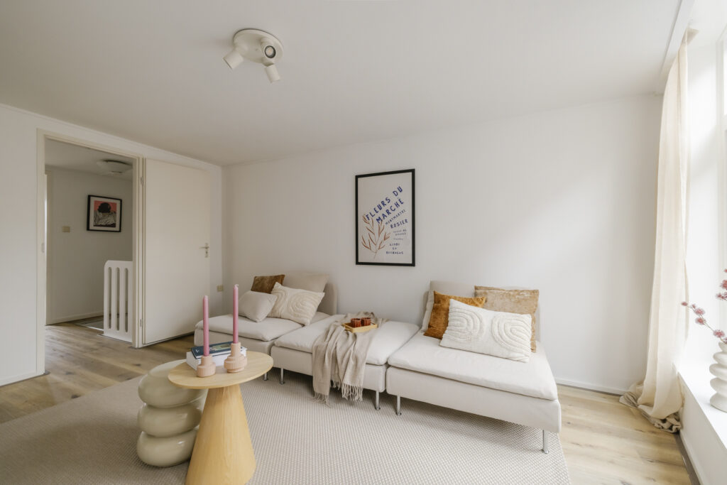 Modern living room with beige sofas and decor.