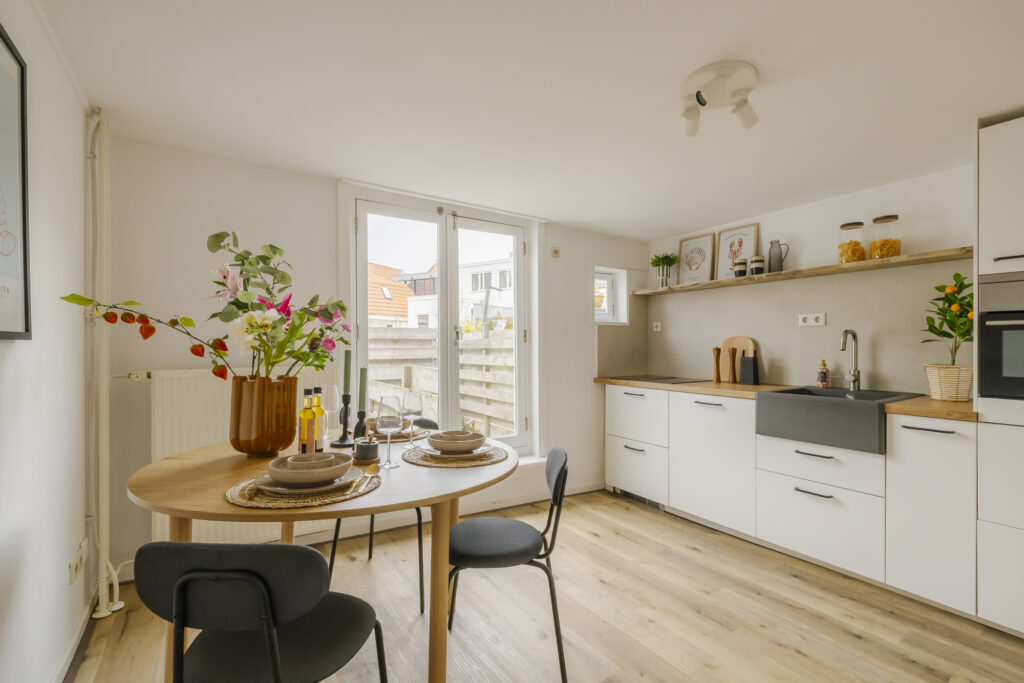 Modern kitchen with table and flowers