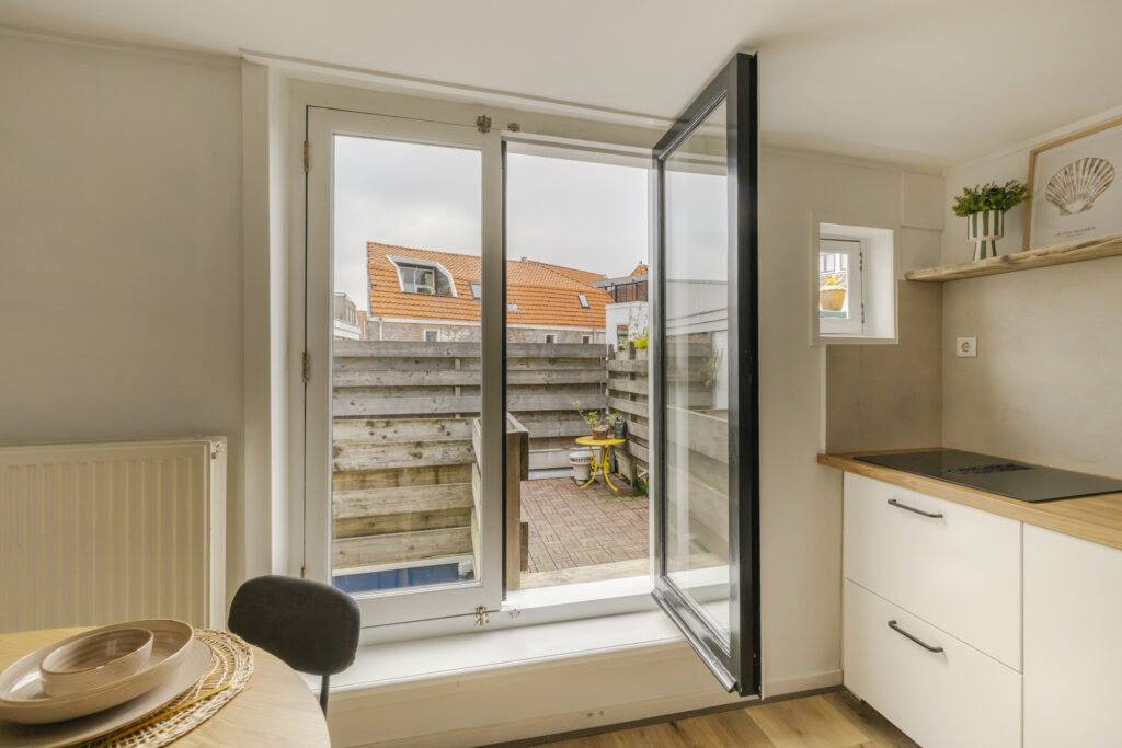 Open kitchen door leading to small outdoor patio.
