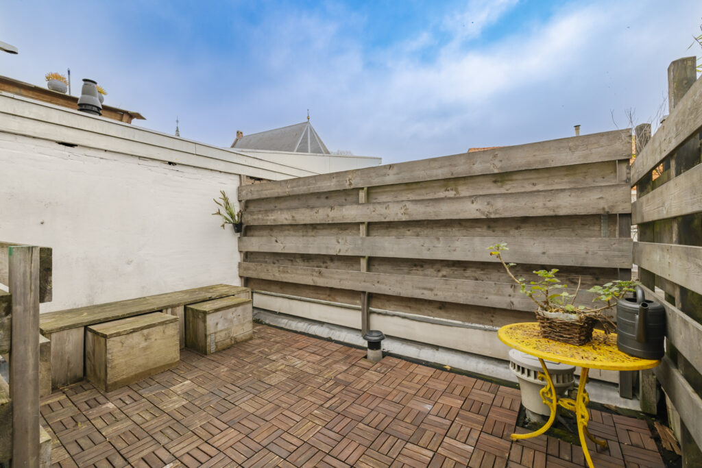 Cozy rooftop patio with rustic wooden seating.