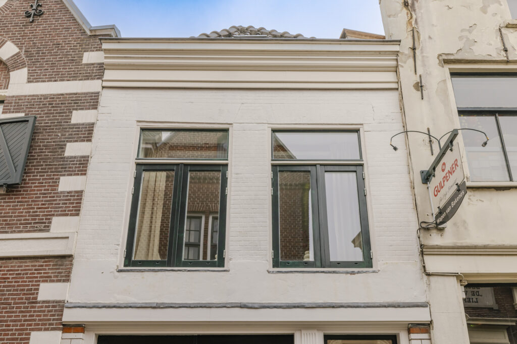 Historic building facade with pub sign, Netherlands.