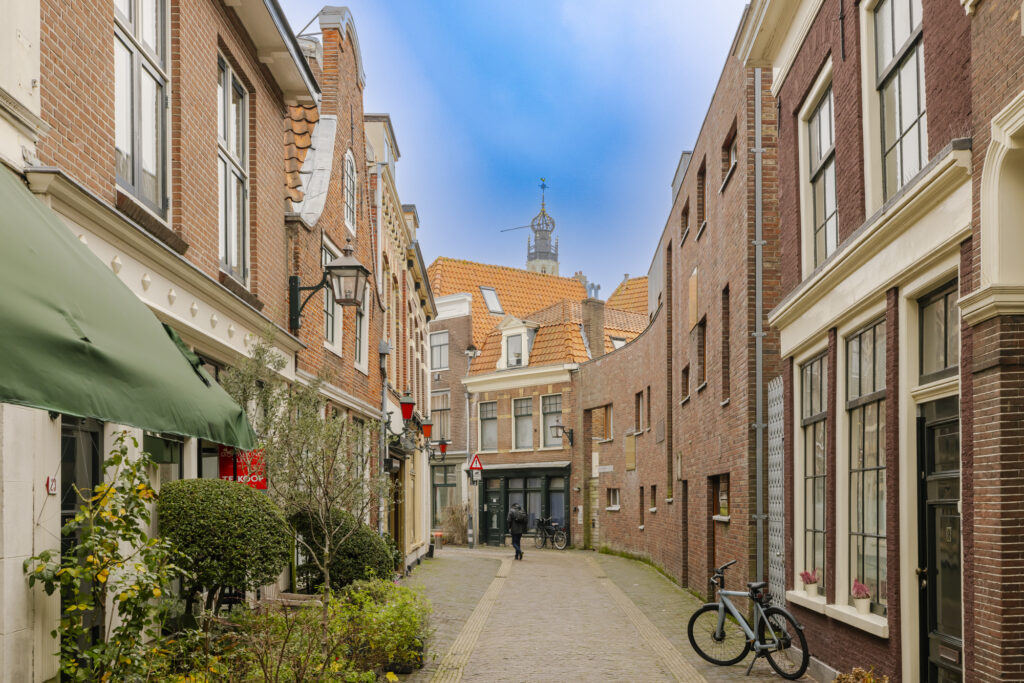 Narrow European street with bicycles and brick buildings.
