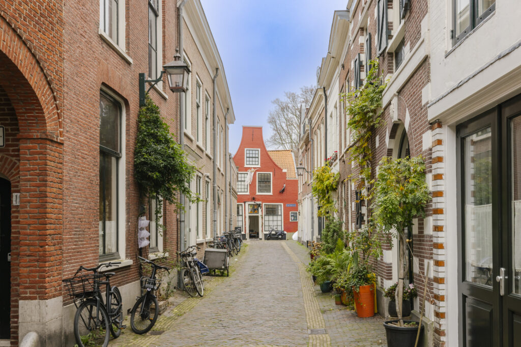 Charming alley with bicycles and brick buildings.