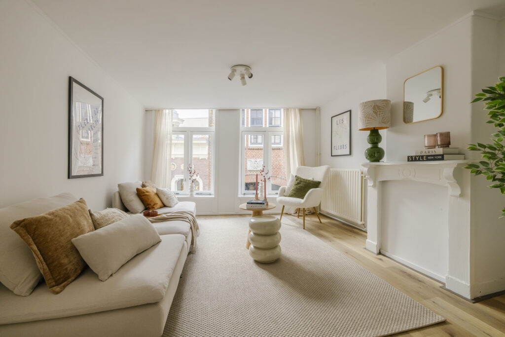 Cozy modern living room with large windows.