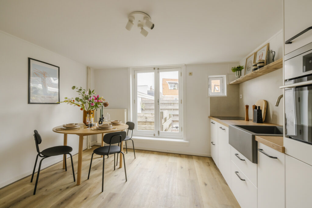 Modern kitchen with dining table and flowers