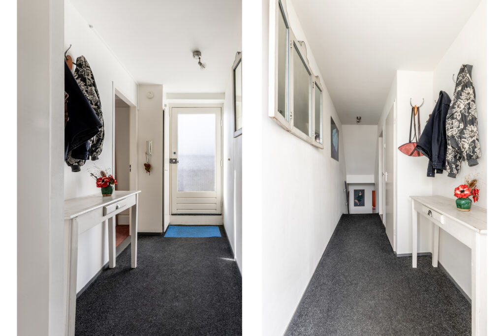 Bright hallway with carpet and white walls.
