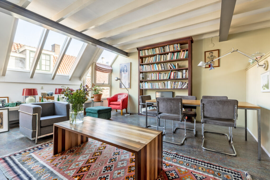 Cozy living room with bookshelves and colorful decor.