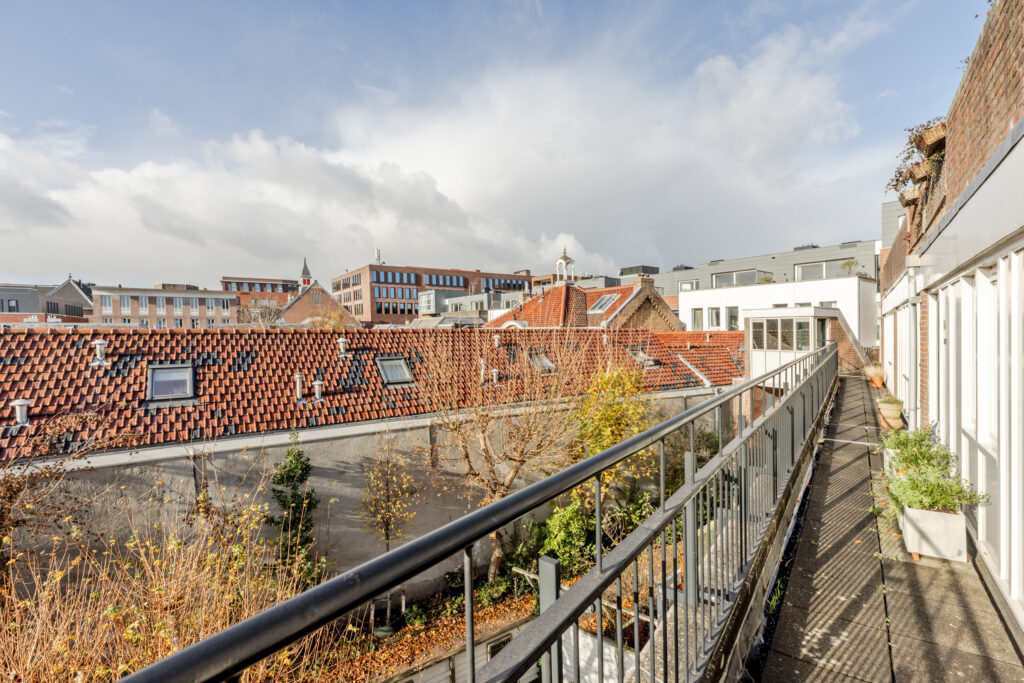 Rooftop view over red brick buildings and courtyard.