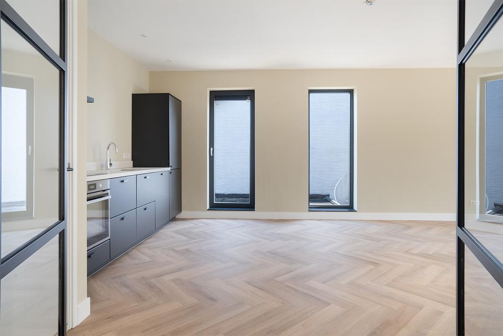 Modern kitchen with herringbone floor and large windows