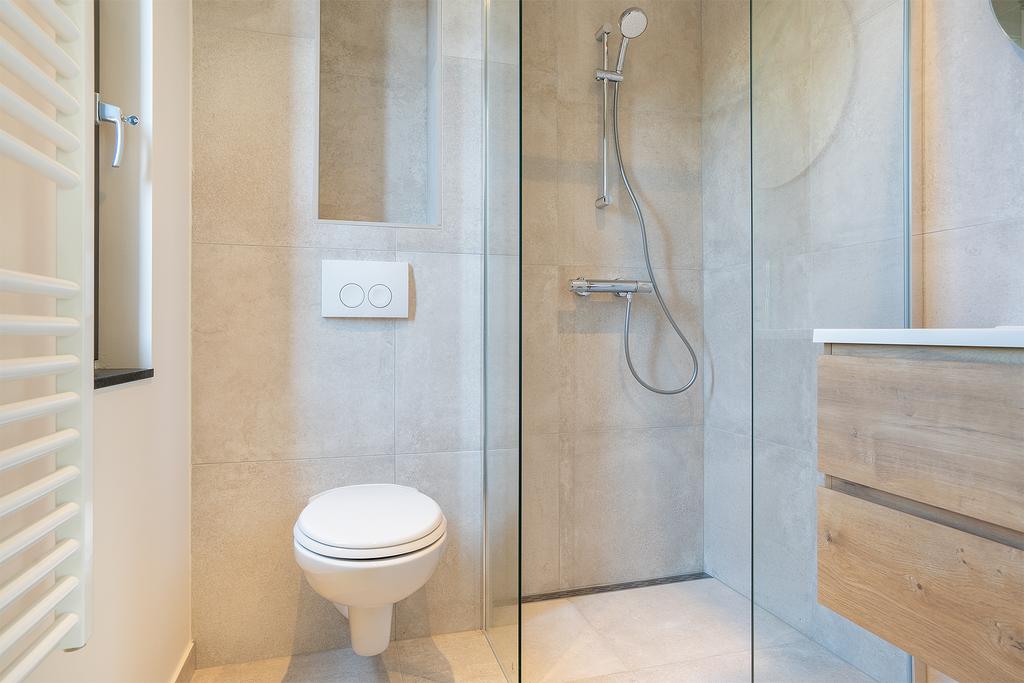 Modern bathroom with glass shower and toilet