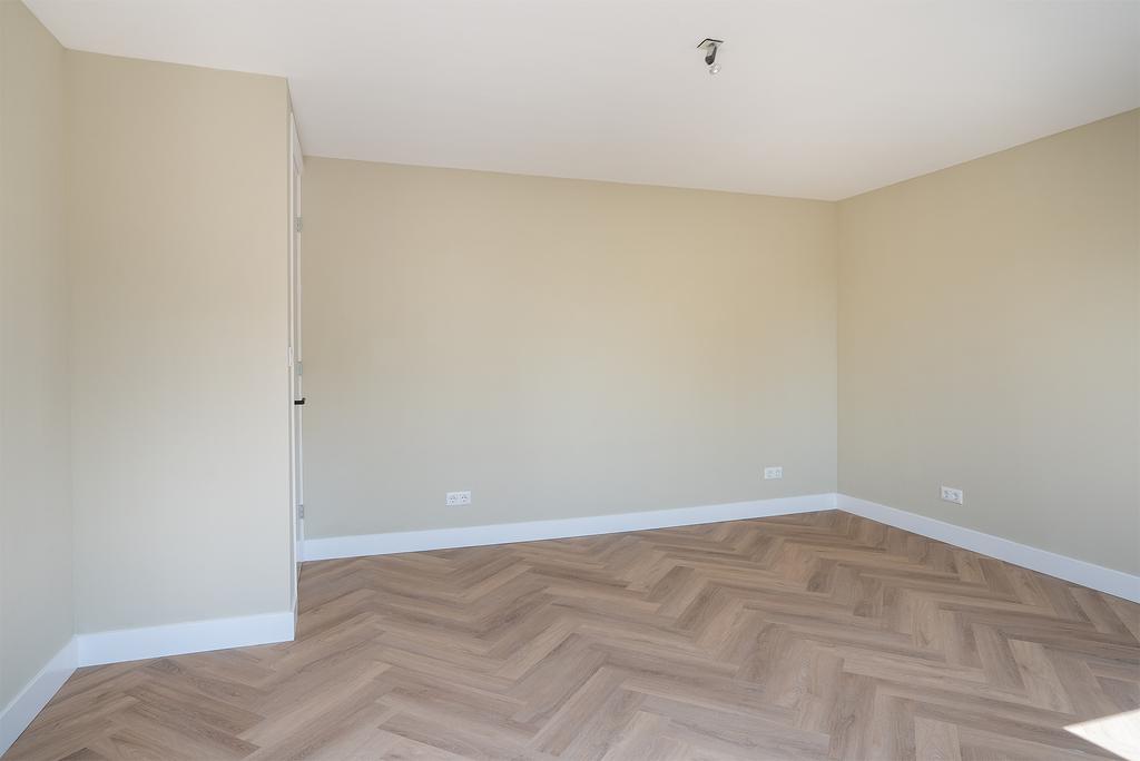 Empty room with herringbone wood flooring