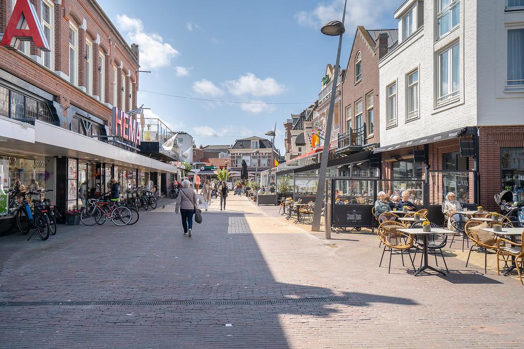 European street scene with cafes and shops.